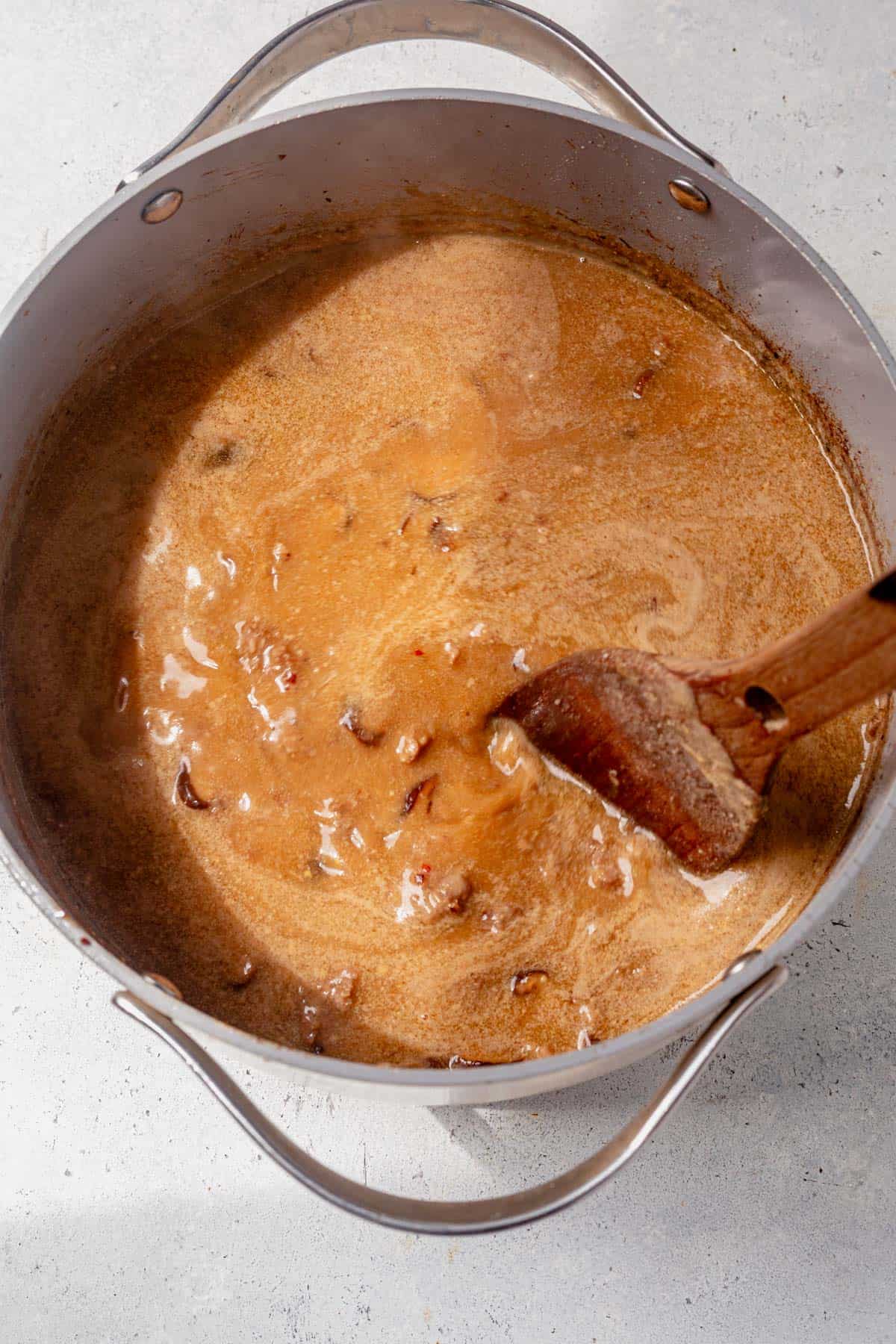 stirring miso pork ramen broth