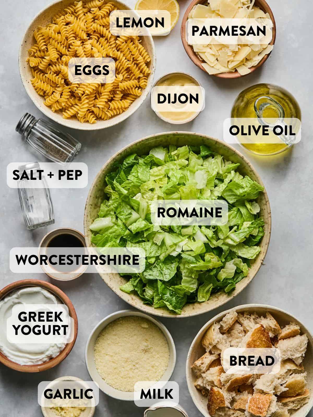 ingredients for caesar pasta salad on a counter.