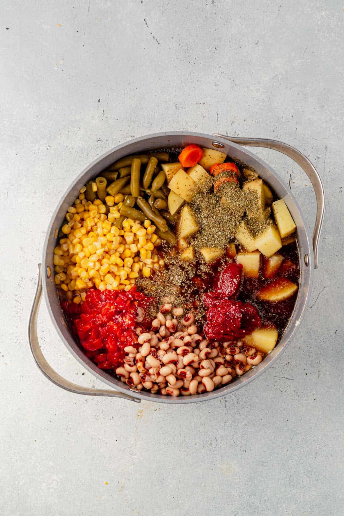 cowboy soup ingredients in a dutch oven before mixing.