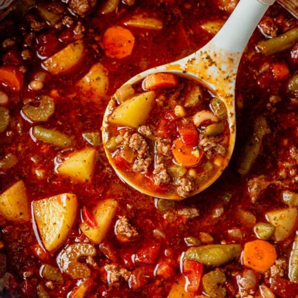 ladling cowboy soup out of a dutch oven.