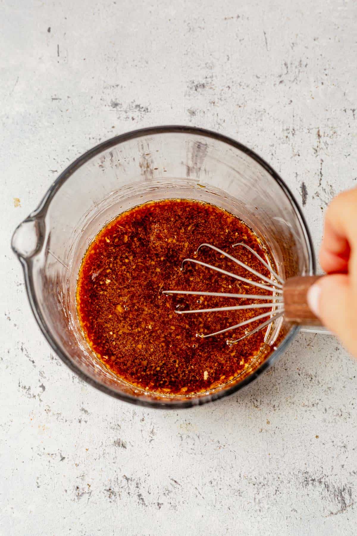 whisking stir fry sauce in a bowl.