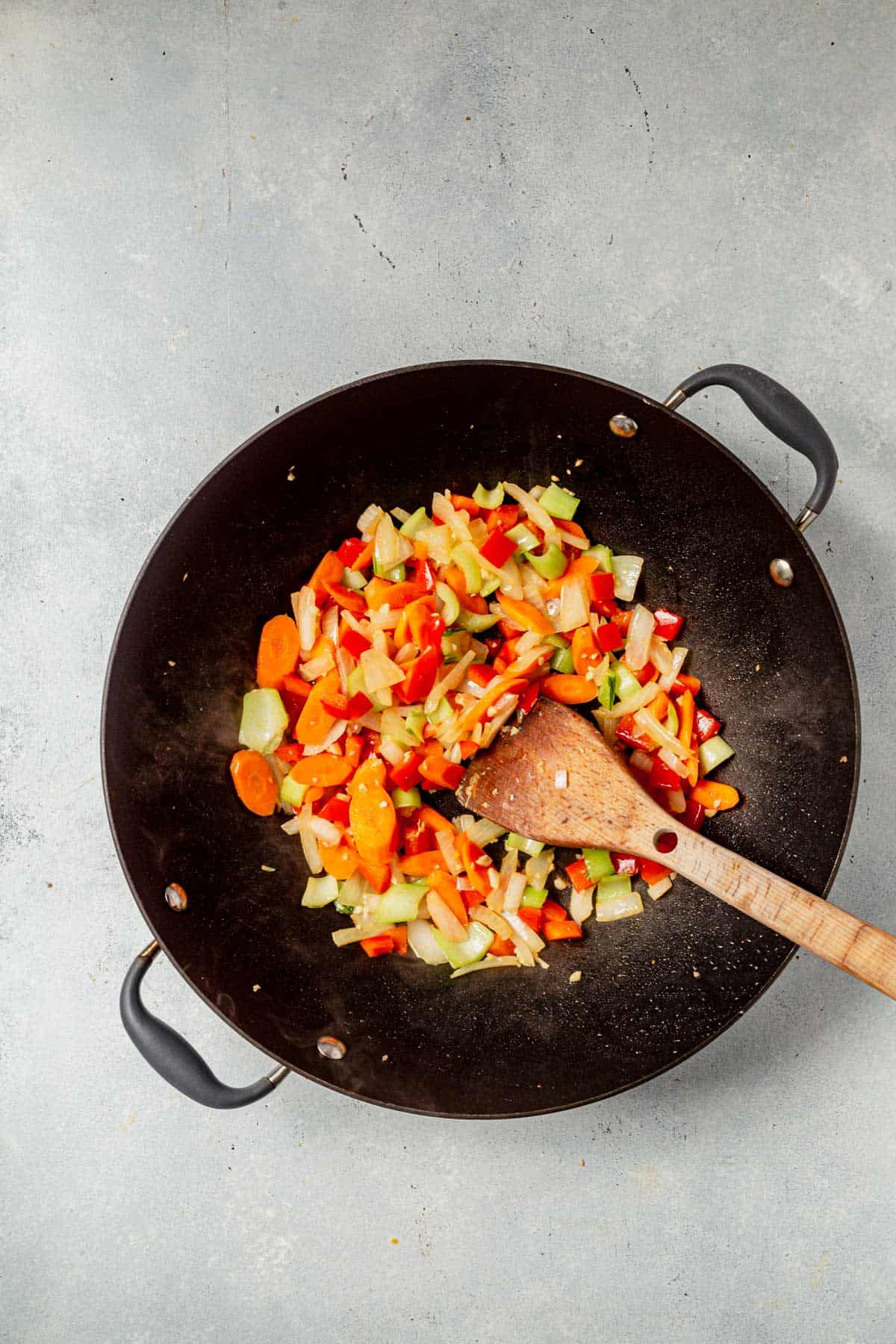 stir fry vegetables cooking in a wok.