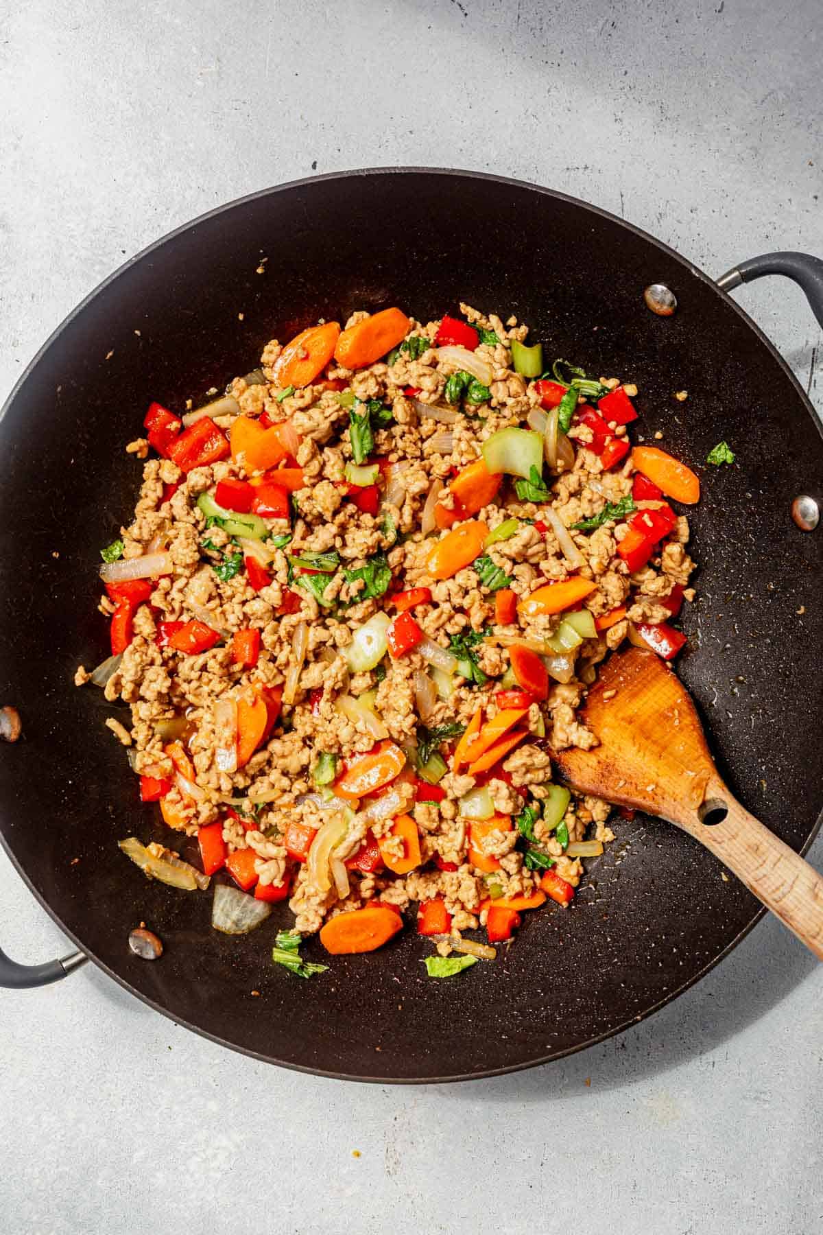 ground pork stir fry mixed together in a wok.