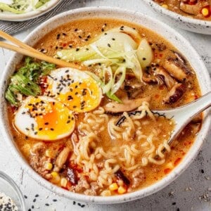 miso pork ramen in a bowl with soy sauce eggs and sesame seeds.