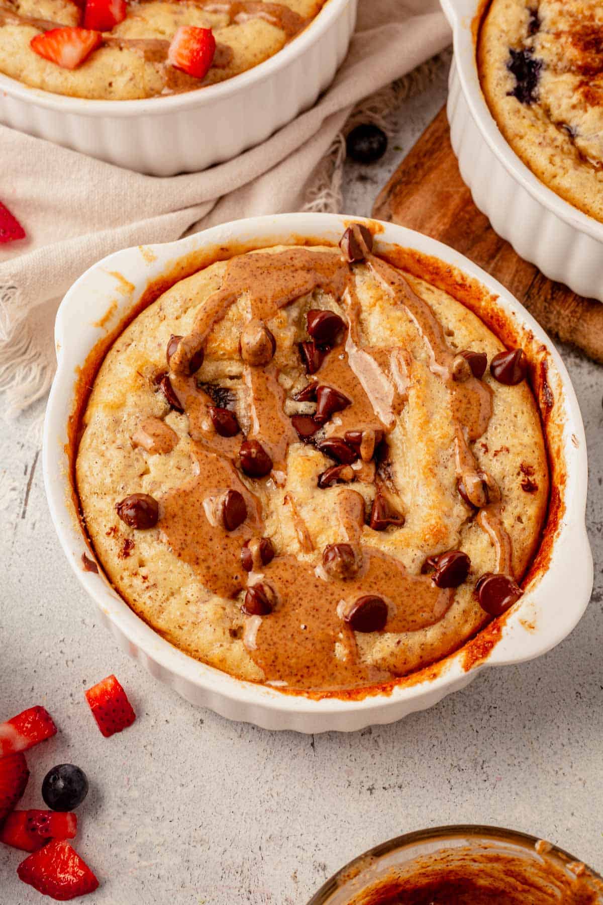 baked protein pancake bowl with almond butter and chocolate chips.