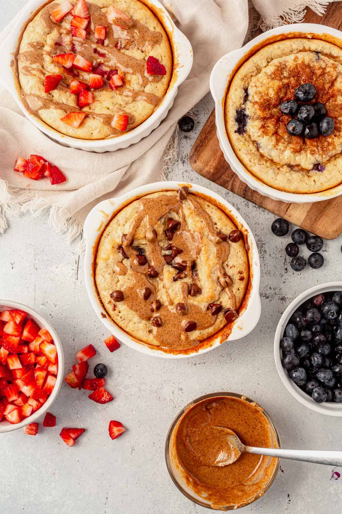 baked protein pancake bowls topped with blueberries, strawberries, and bananas.