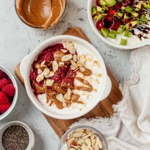 two sweet and savory breakfast bowls on a countertop.