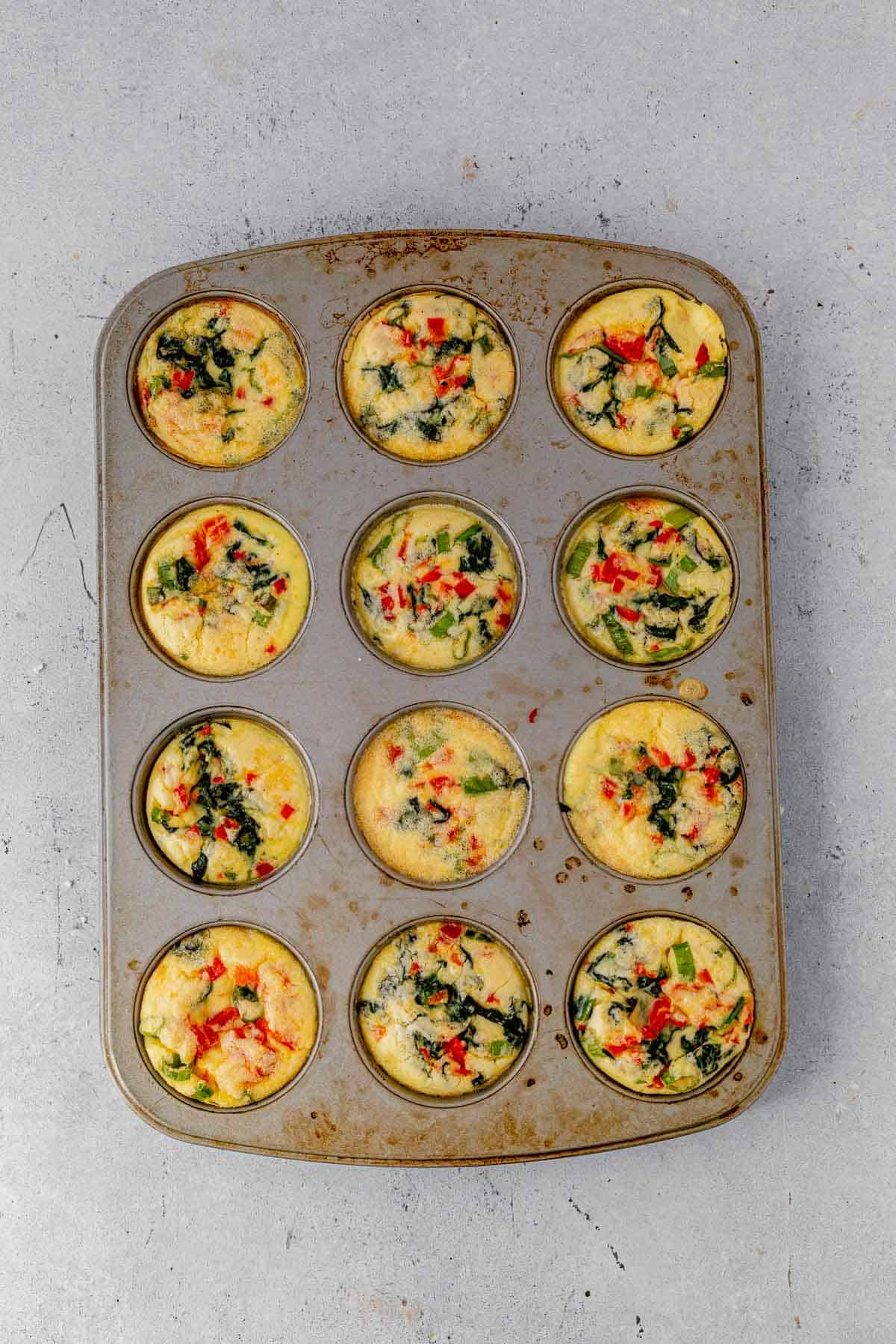 baked cottage cheese egg bites cooling in muffin tins.