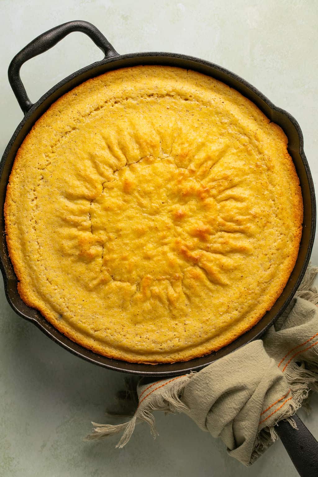 fresh baked gluten free cornbread in a cast iron skillet.