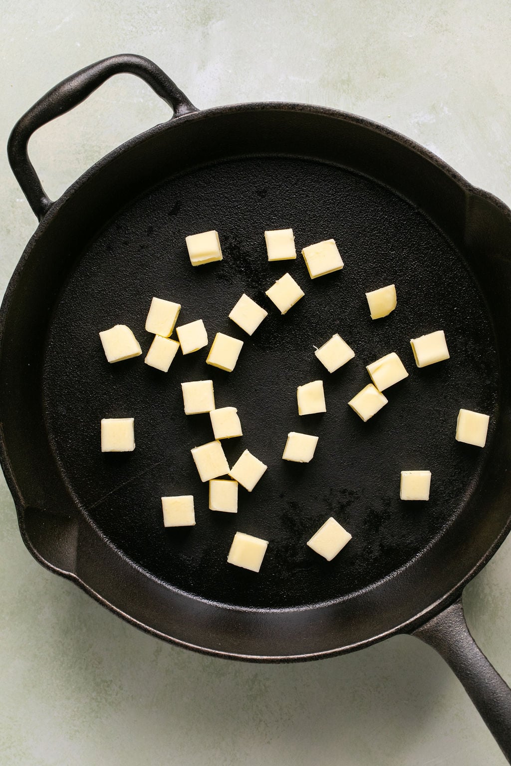 cubed butter in a cast iron skillet.