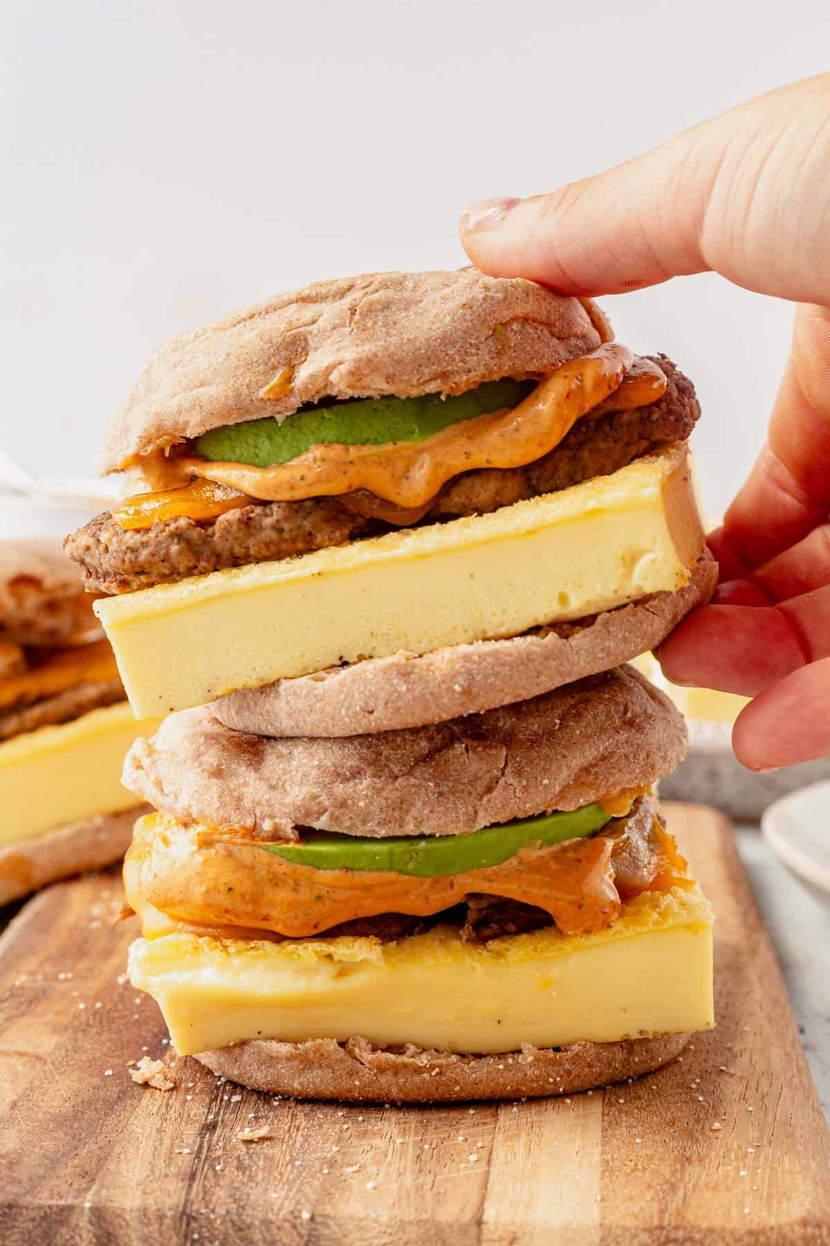 two protein breakfast sandwiches stacked on a platter.