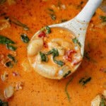 a ladle of marry me chicken soup coming out of the soup pot.