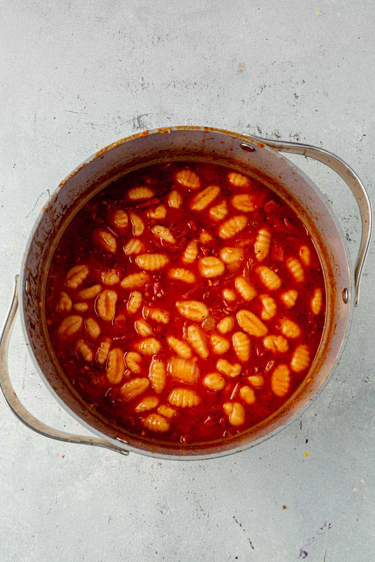 Cooked gnocchi in marry me chicken soup broth.