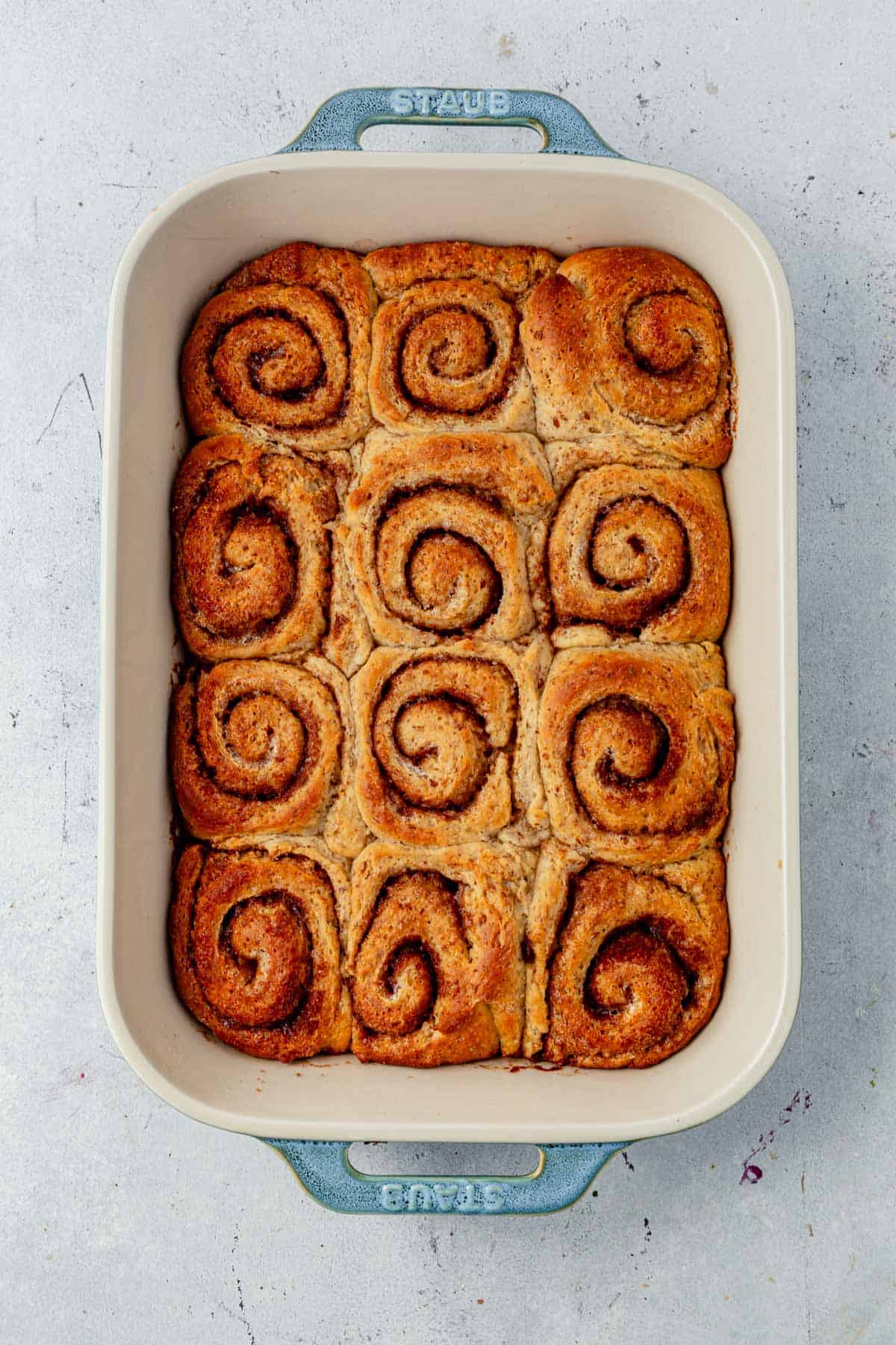 baked cinnamon rolls in a baking dish.