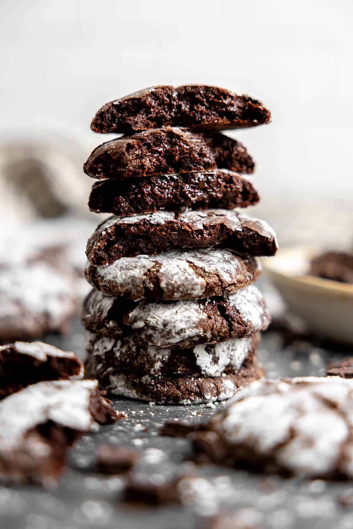 a stack of gluten free chocolate crinkle cookies on a countertop.