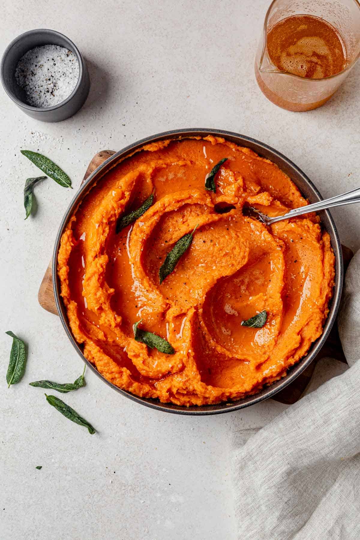 mashed potatoes with brown butter and crispy sage in a bowl.