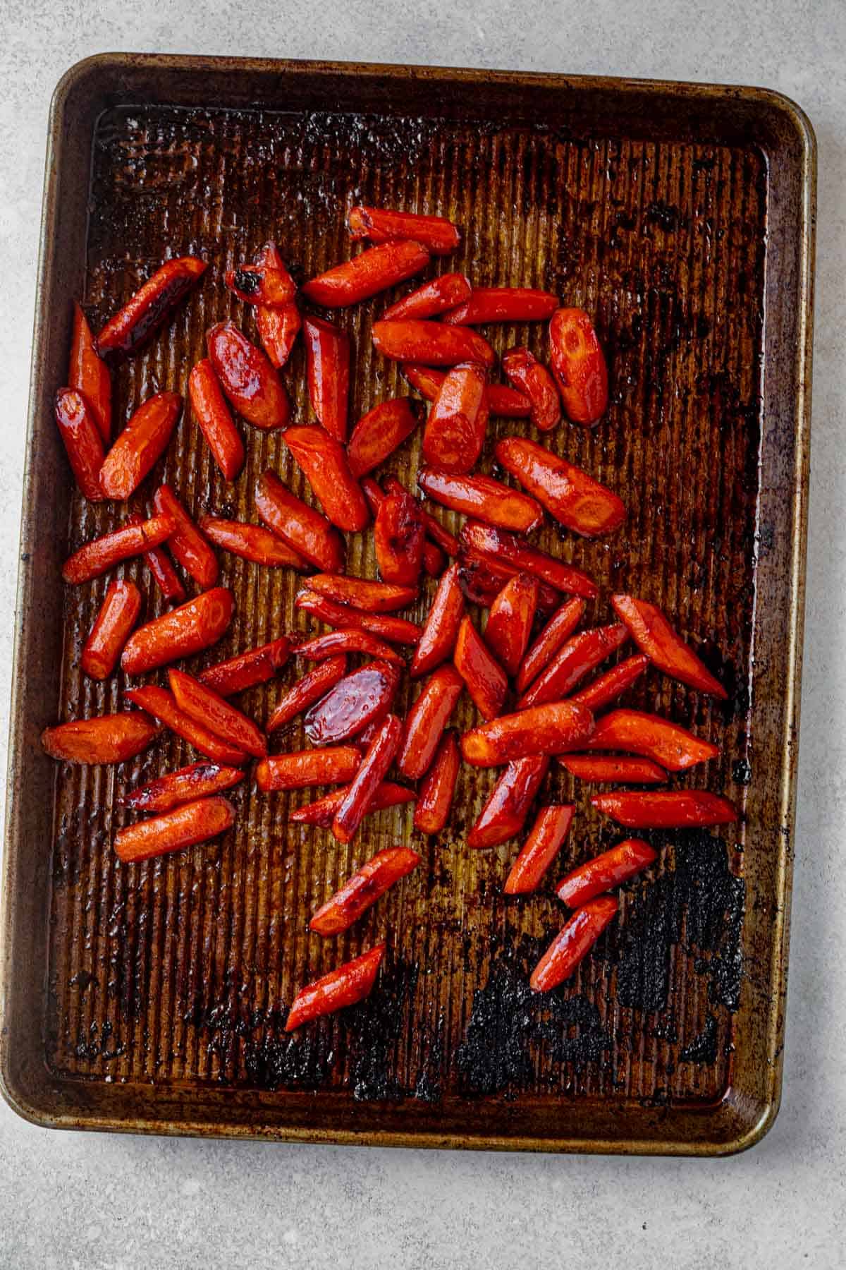 brown sugar baked carrots baked on a sheet pan.