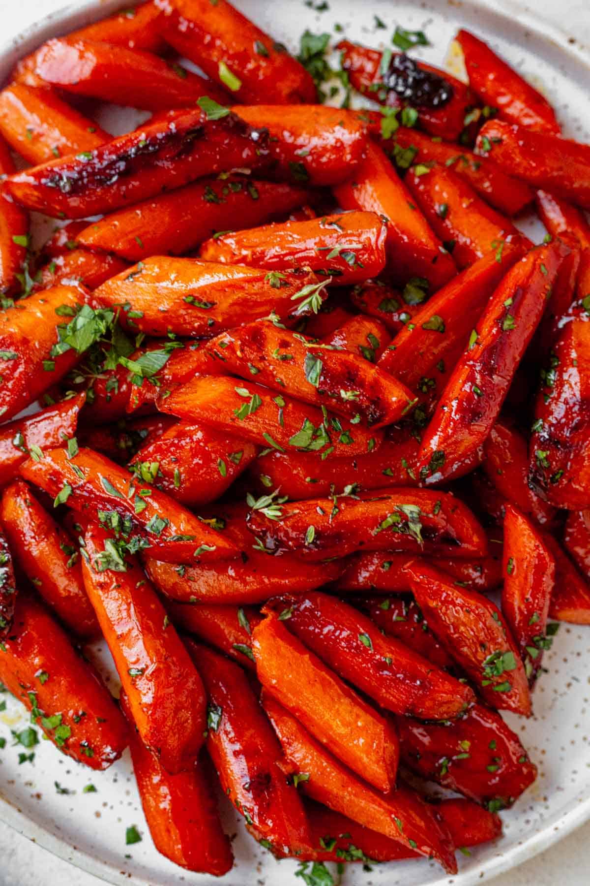 brown sugar baked carrots on a sheet pan with caramelized edges.