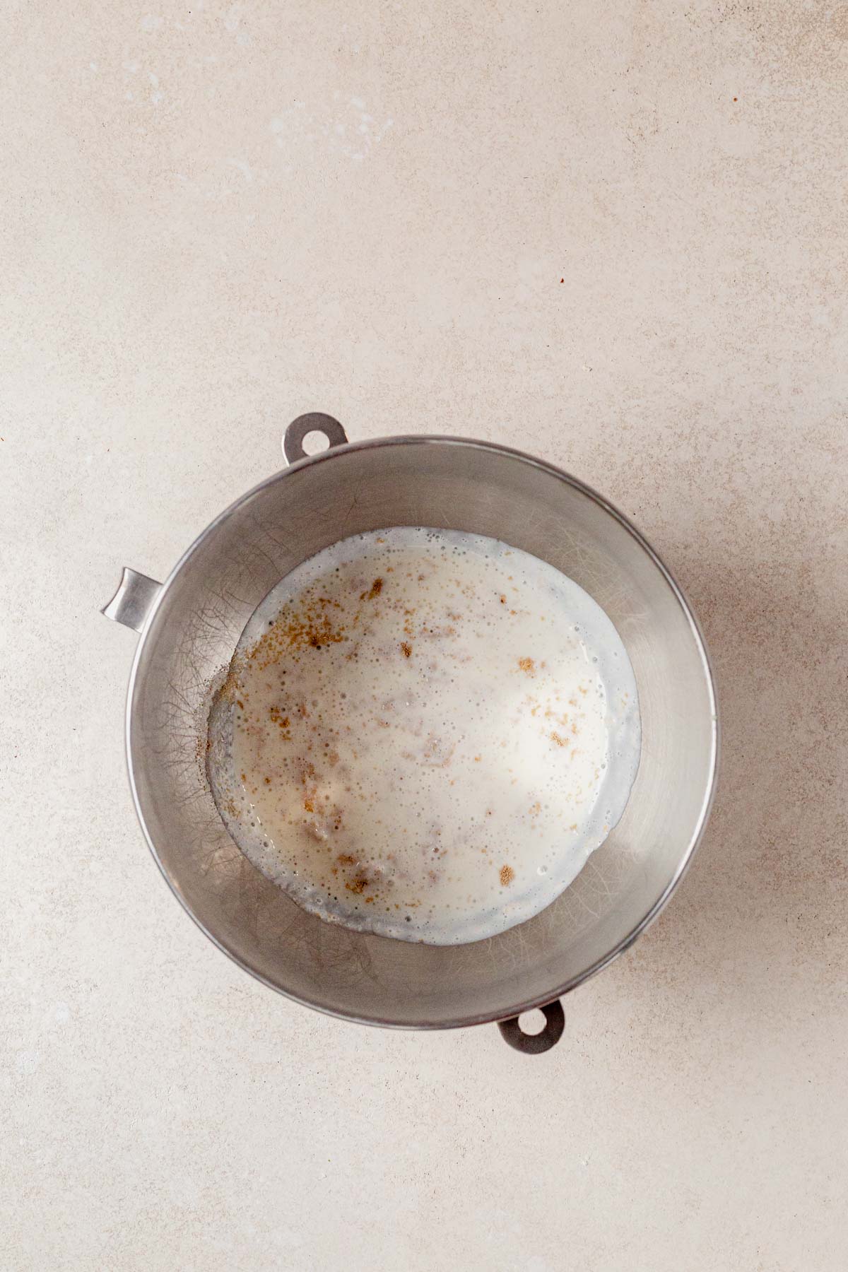 yeasting proofing in a bowl with milk and cottage cheese.