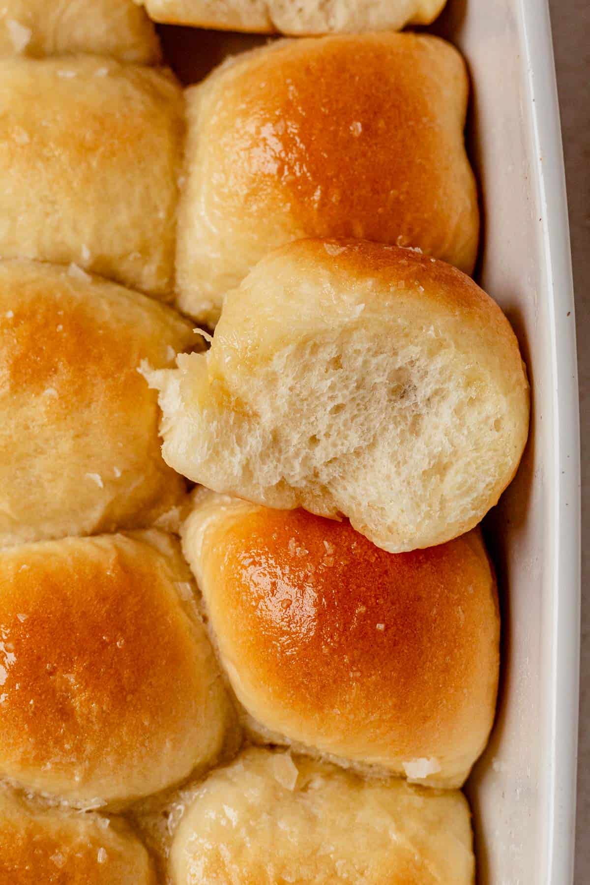 a cottage cheese dinner roll being pulled out of the pan.