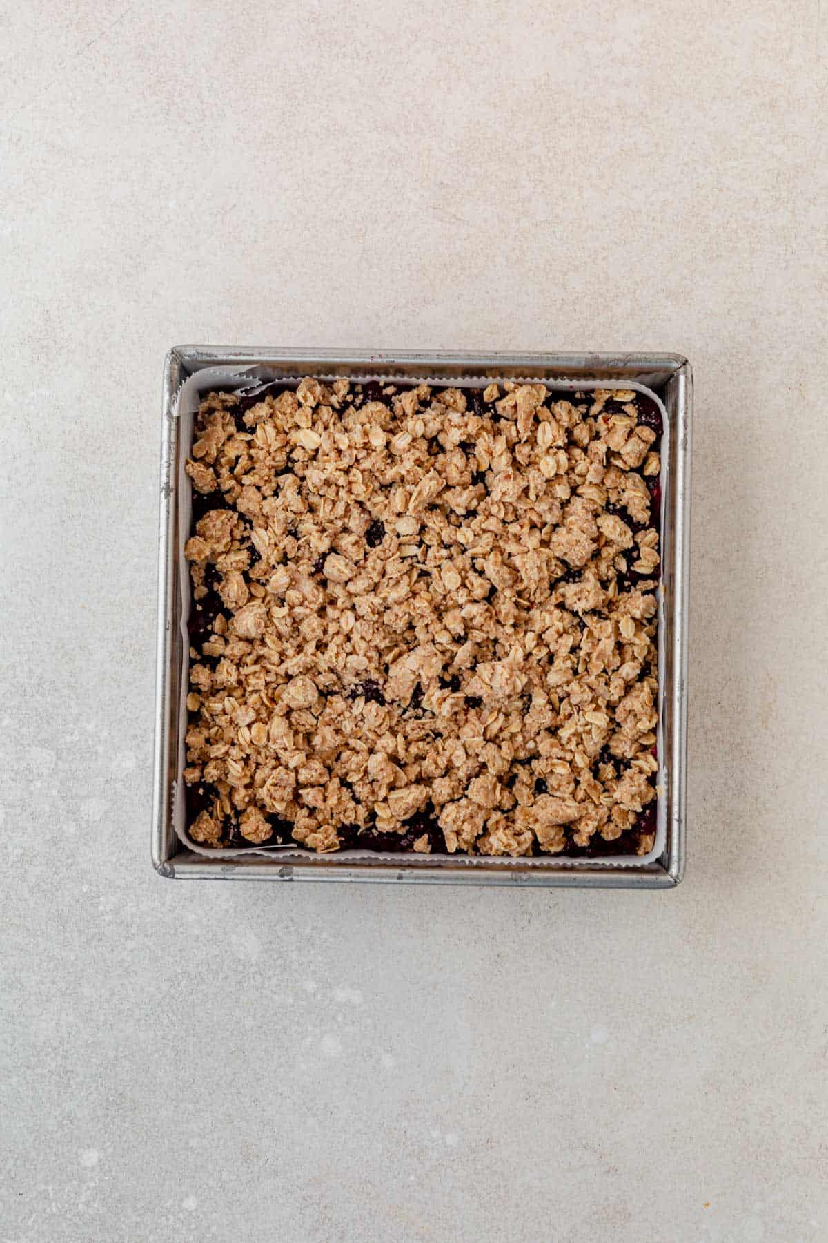 unbaked cranberry oatmeal bars on a countertop.