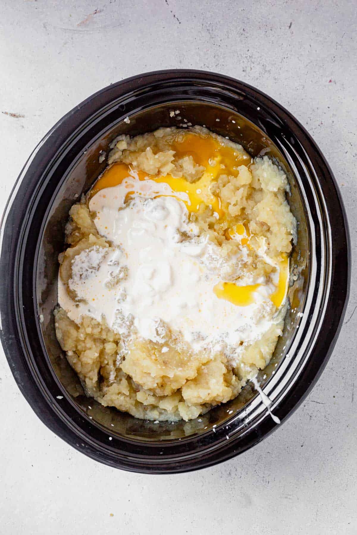 butter and cream on top of potatoes cooked in the crock pot.