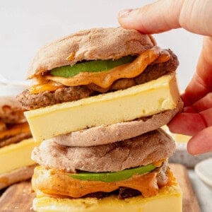 high protein breakfast sandwiches stacked on a cutting board.