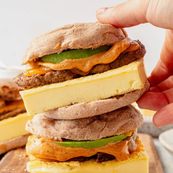 high protein breakfast sandwiches stacked on a cutting board.