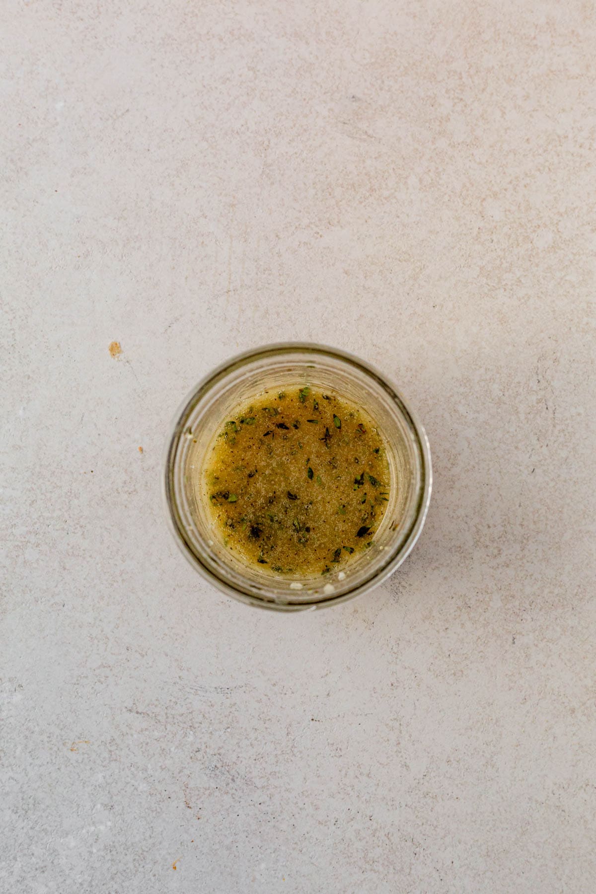 Spiced maple vinaigrette mixed in a mason jar.