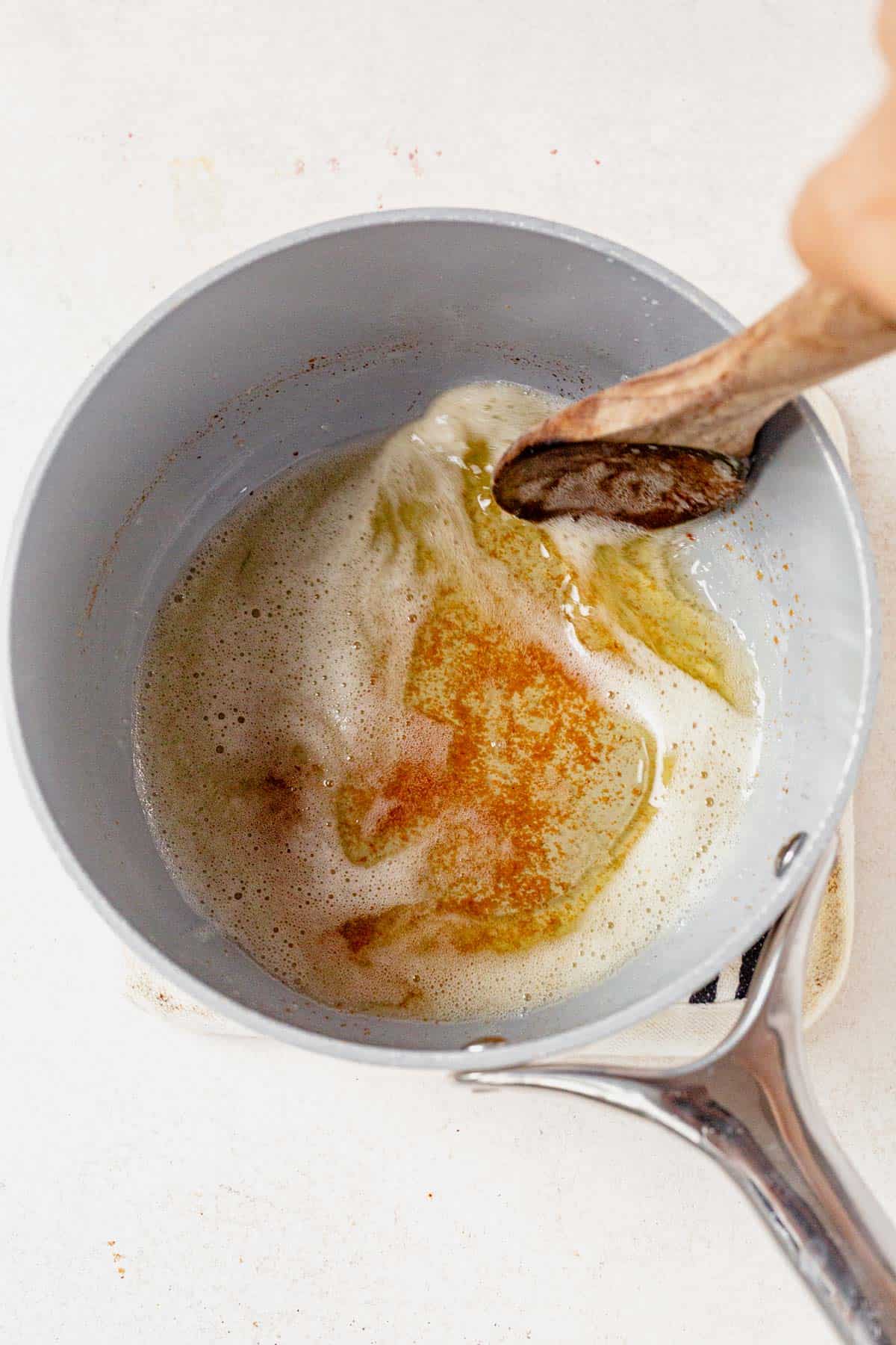 swirling brown butter in a pan.