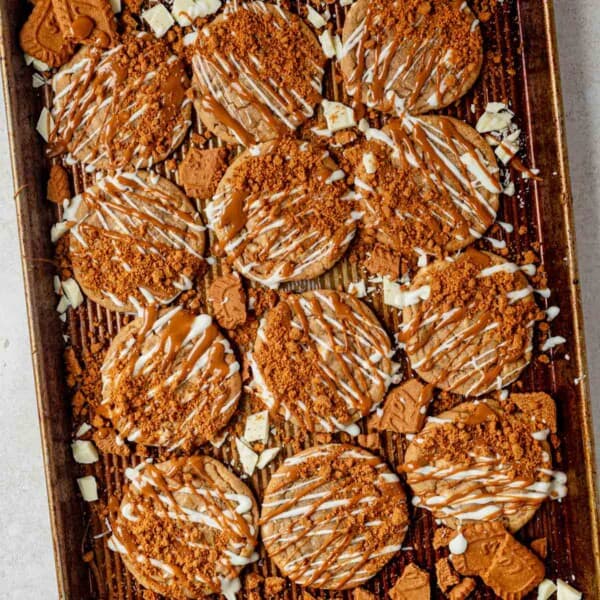 a cookie tray of biscoff cookies decorated with white chocolate and cookie butter.