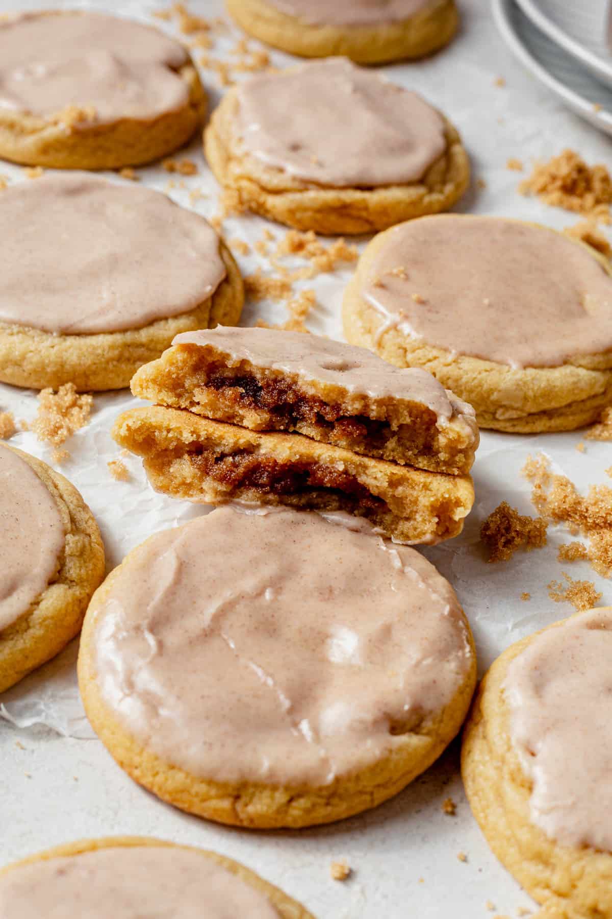 a batch of brown sugar pop tart cookies with one broken in half.