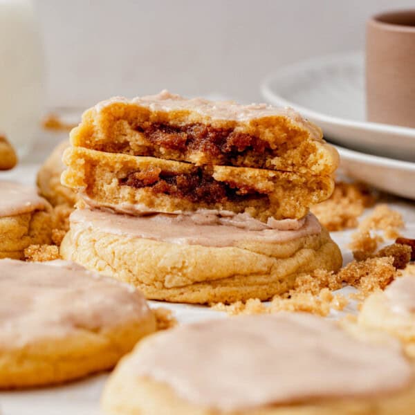 a brown sugar pop tart cookie broken in half and stacked on another cookie.