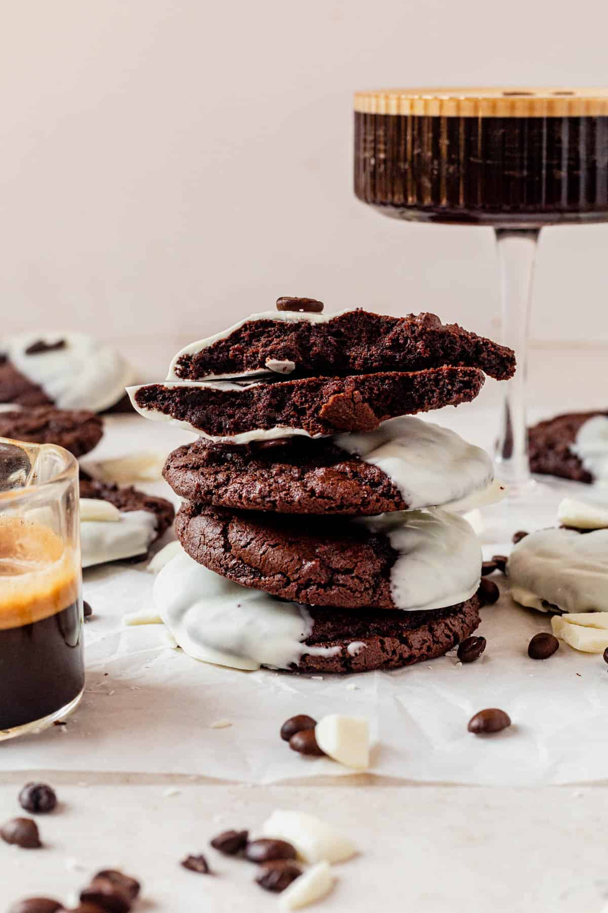 a stack of espresso martini cookies next to an espresso martini.