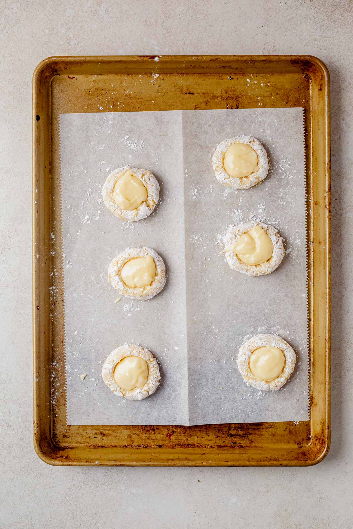 unbaked gooey butter cake cookies on a baking sheet.