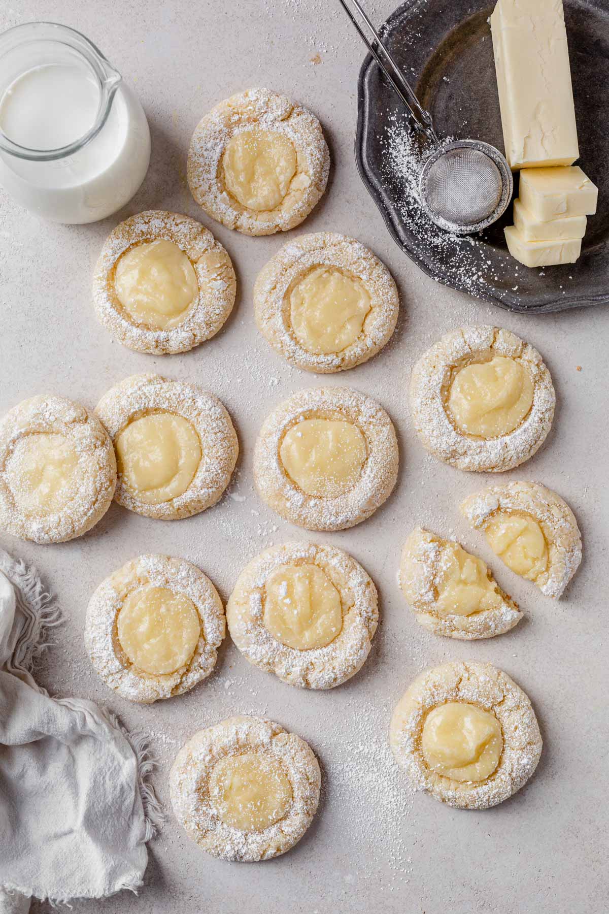 a batch of gooey butter cake cookies on a countertop.