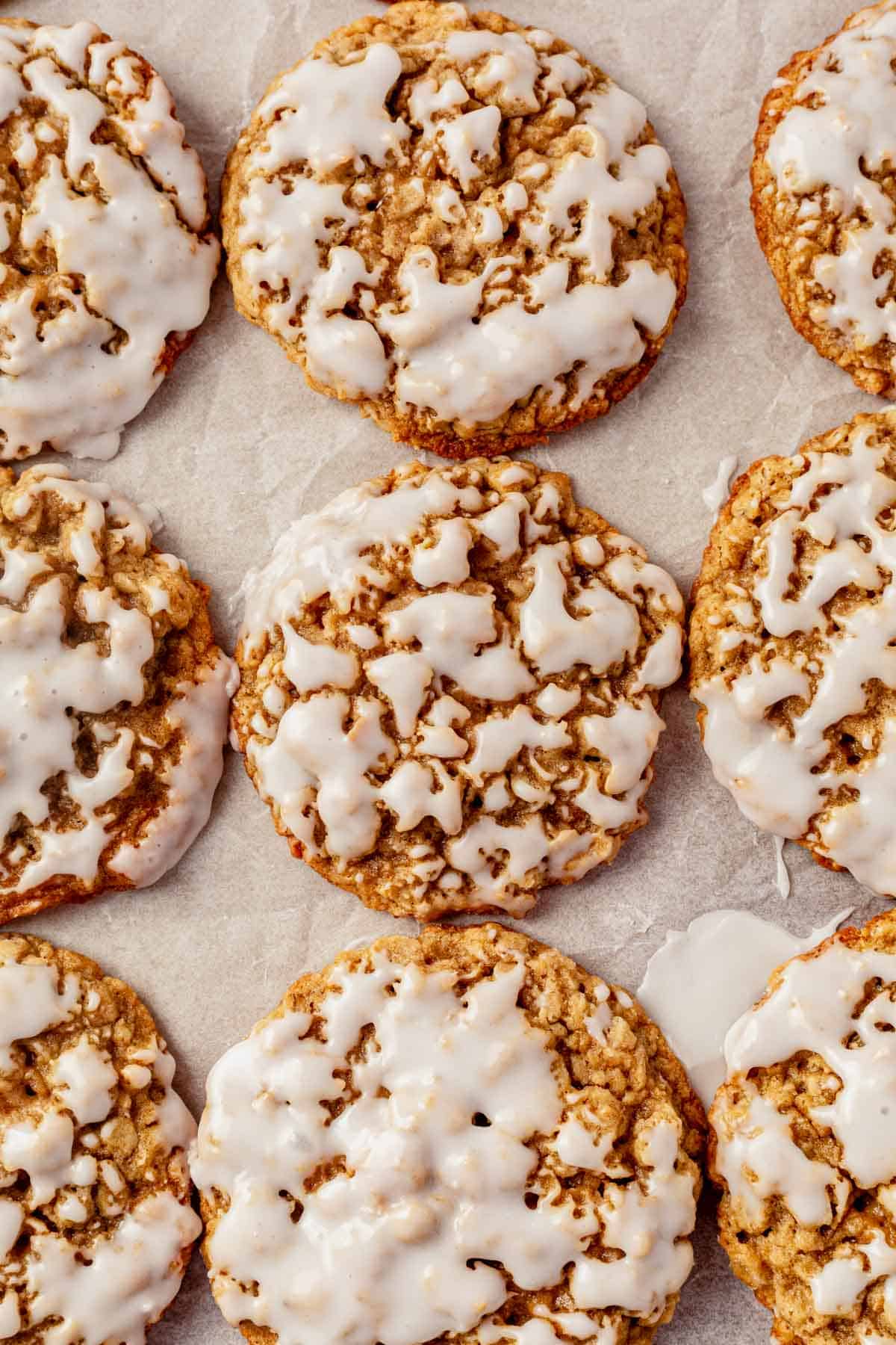 iced oatmeal cookies cooling on a cookie sheet.