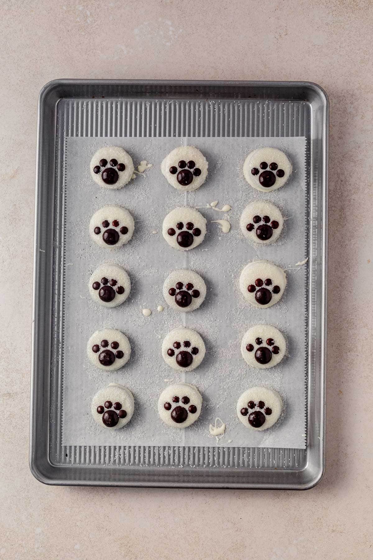 polar bear paw oreos setting on a cookie sheet.