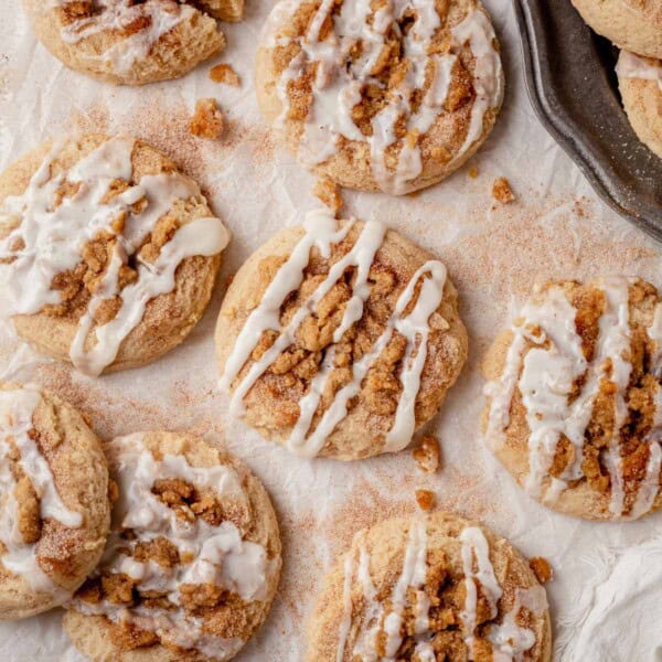 coffee cake cookies with icing on a piece of parchment paper.