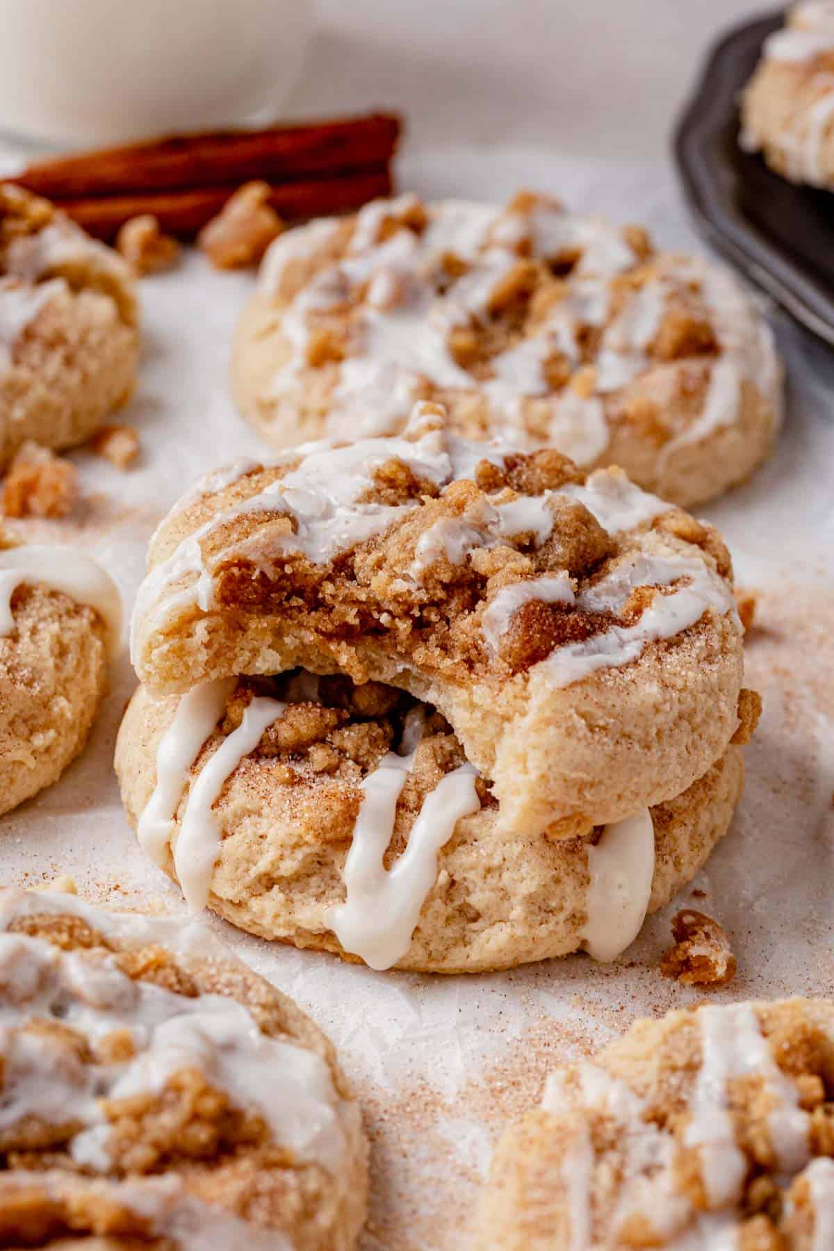 two coffee cake cookies stacked on a piece of parchment paper.