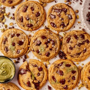 a batch of brown butter pistachio cookies on a counter.