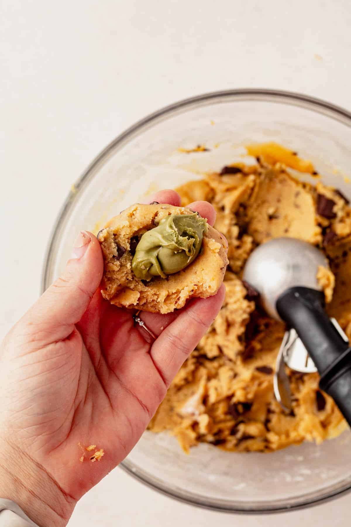 stuffing pistachio cream inside brown butter cookie dough.