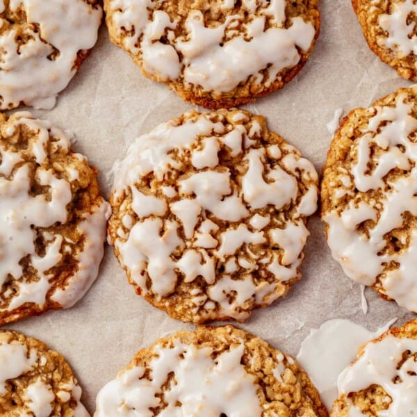 iced oatmeal cookies on a sheet pan.