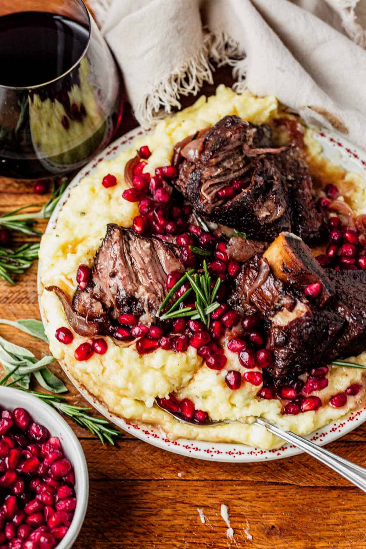 pomegranate short ribs on top of mashed potatoes.