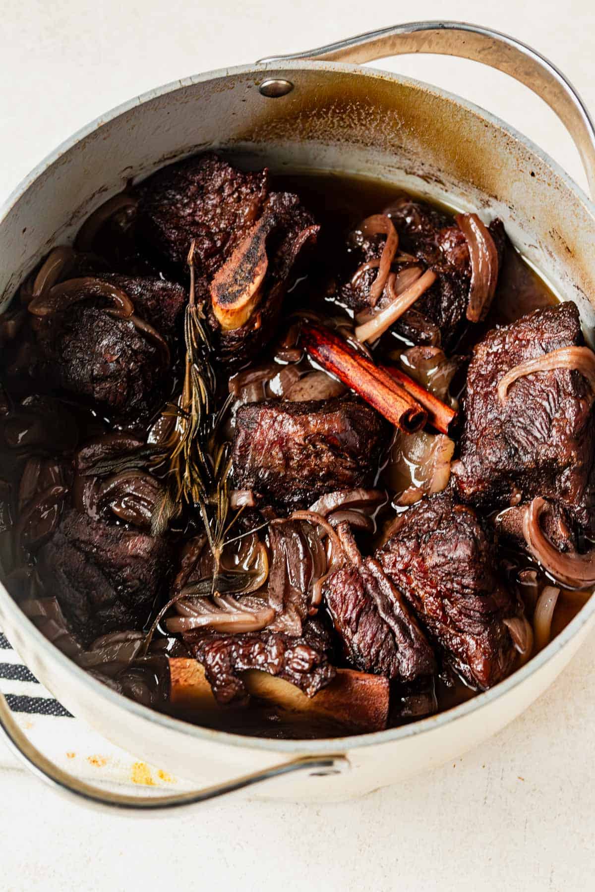 pomegranate braised short ribs cooked in a dutch oven.