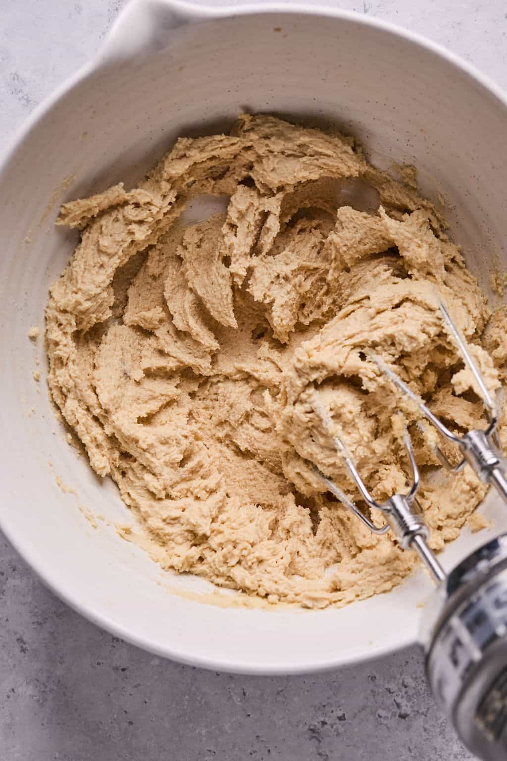 creaming butter and sugar in a mixing bowl with a hand mixer.