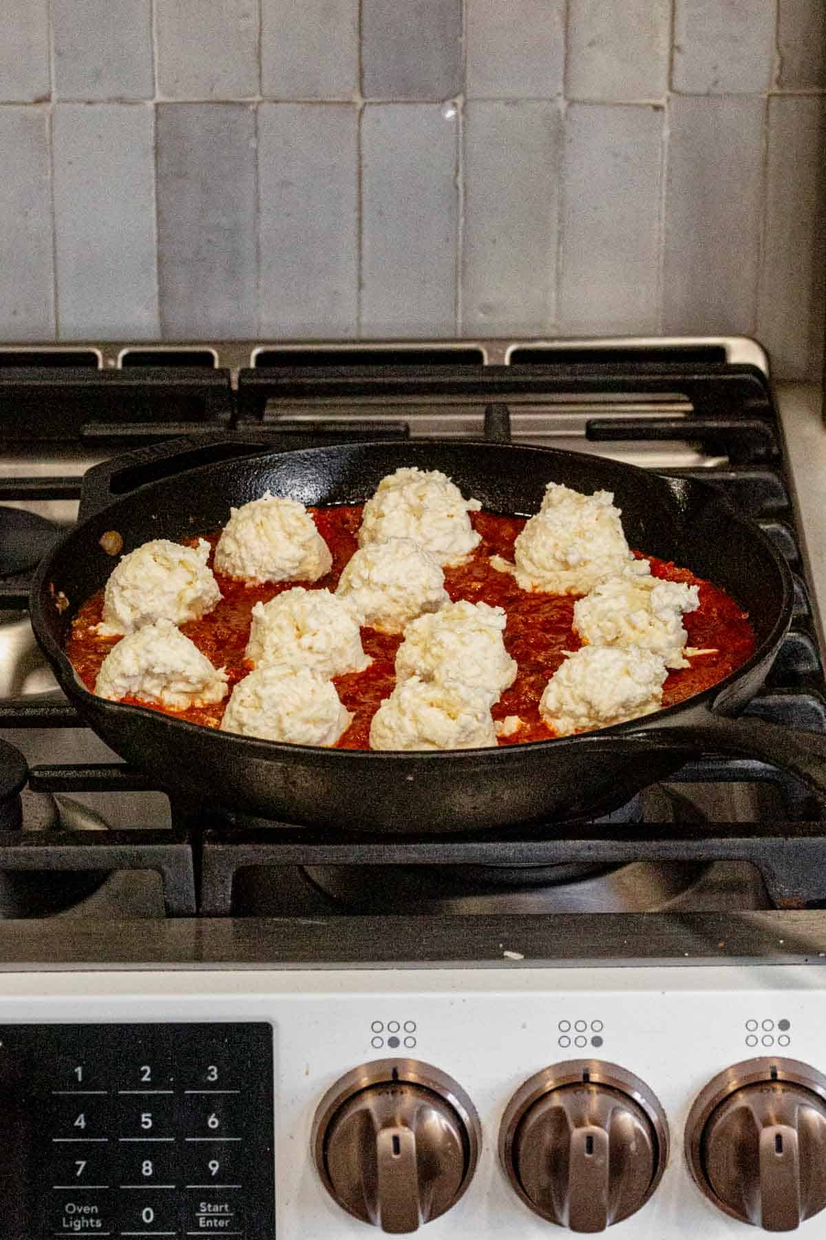 lasagna dip in a skillet before baking.