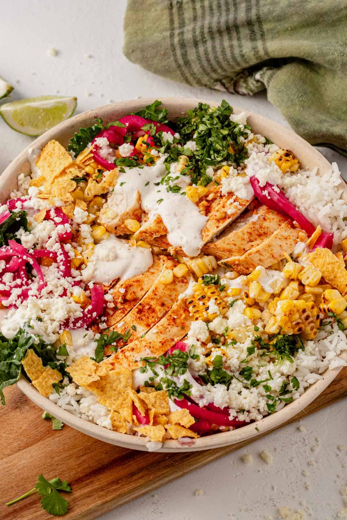 street corn rice bowl topped with red onion and cilantro.