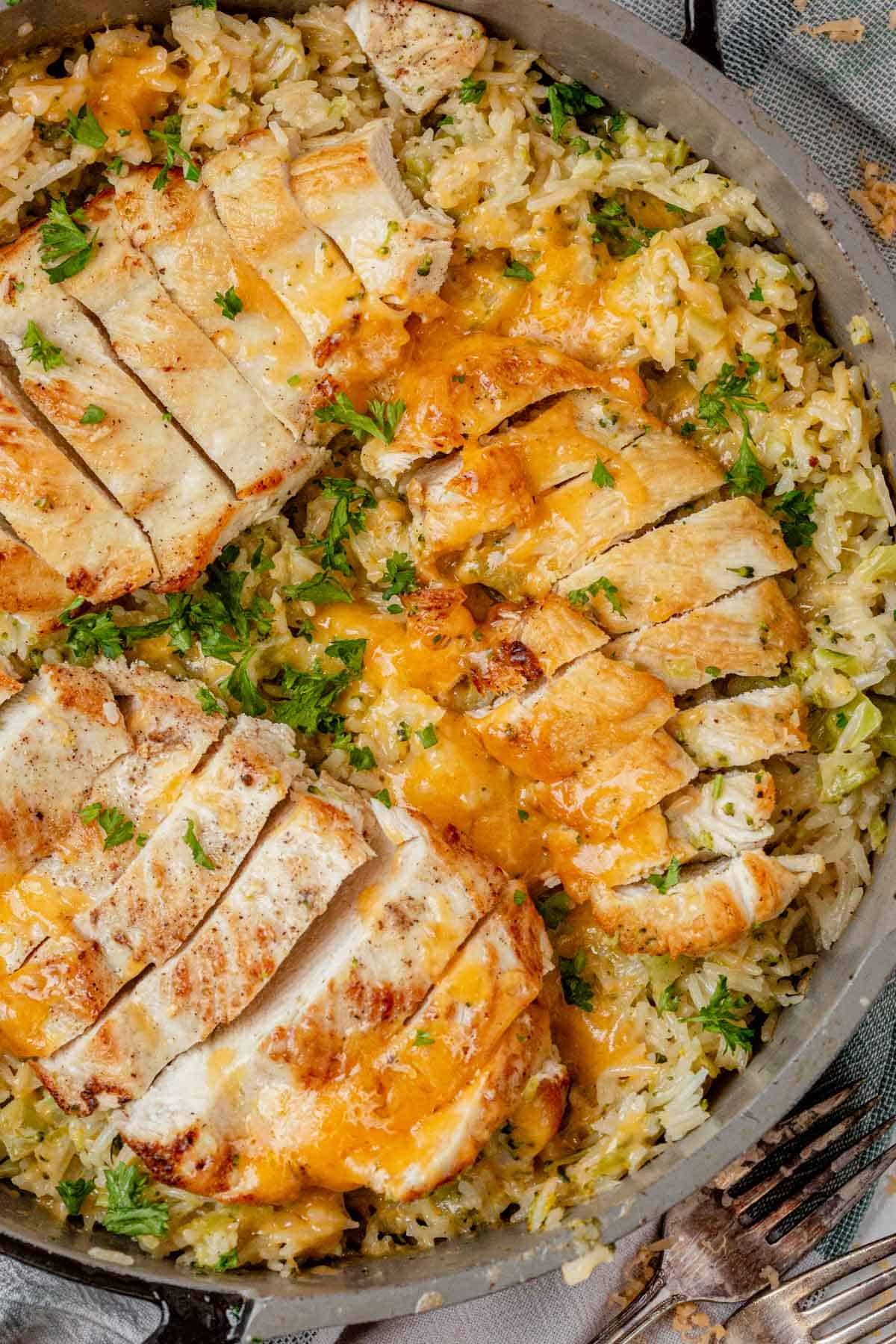 one pan cheesy chicken broccoli and rice in a skillet.