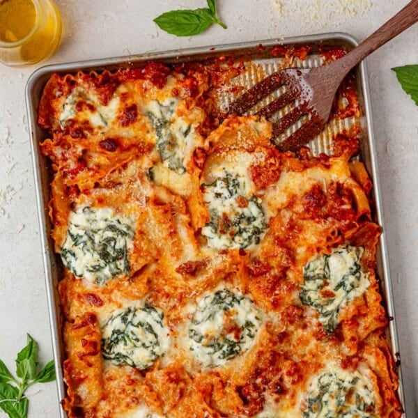 sheet pan lasagna with a spatula.